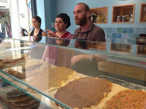 Andreas and mother Feyrouz explain the different flavours of Lahmajoun Photo: Heatheronhertravels.com